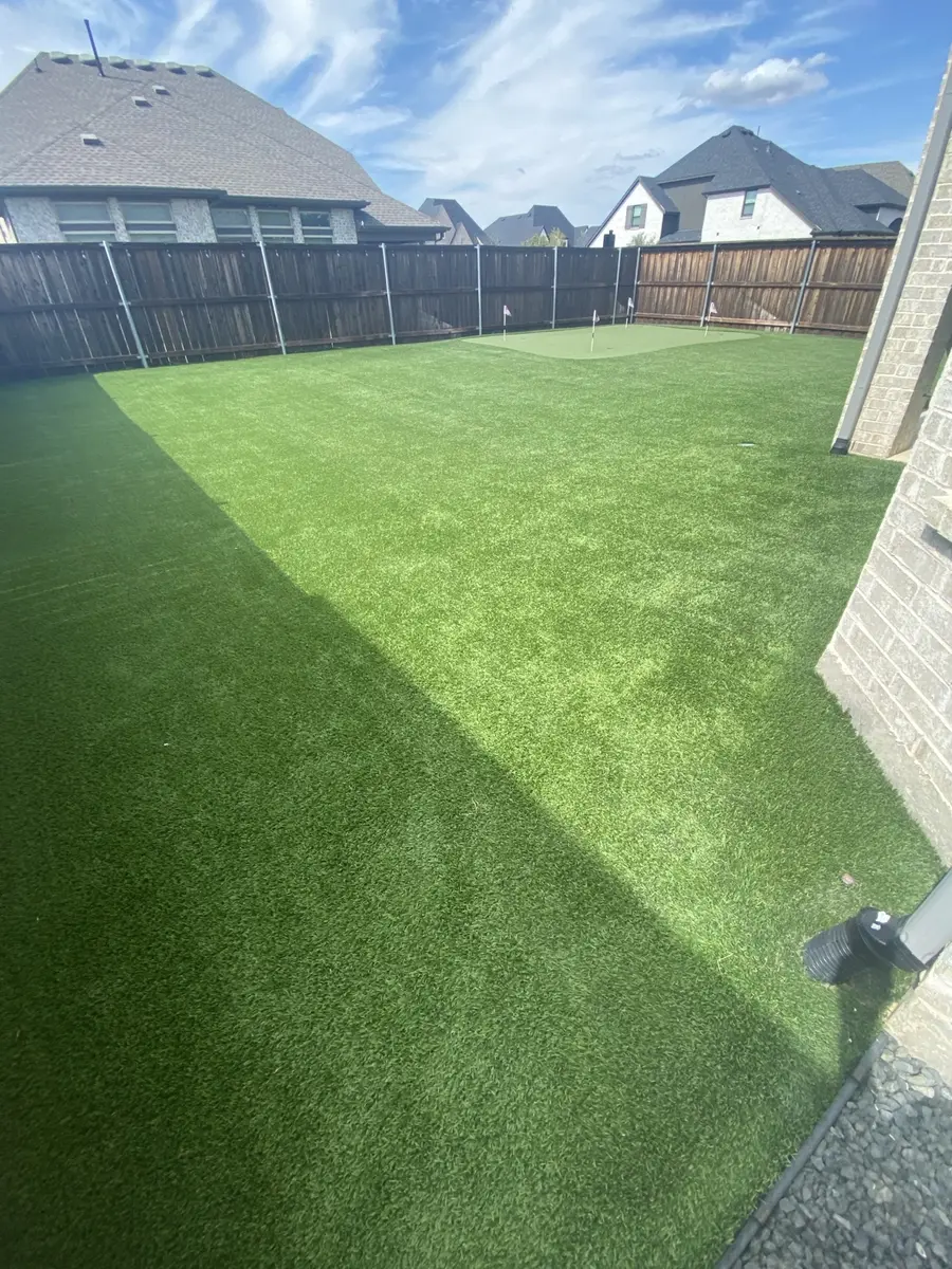 Finished 1,500-square-foot residential artificial turf lawn and putting green after professional cleaning in Aubrey, Texas