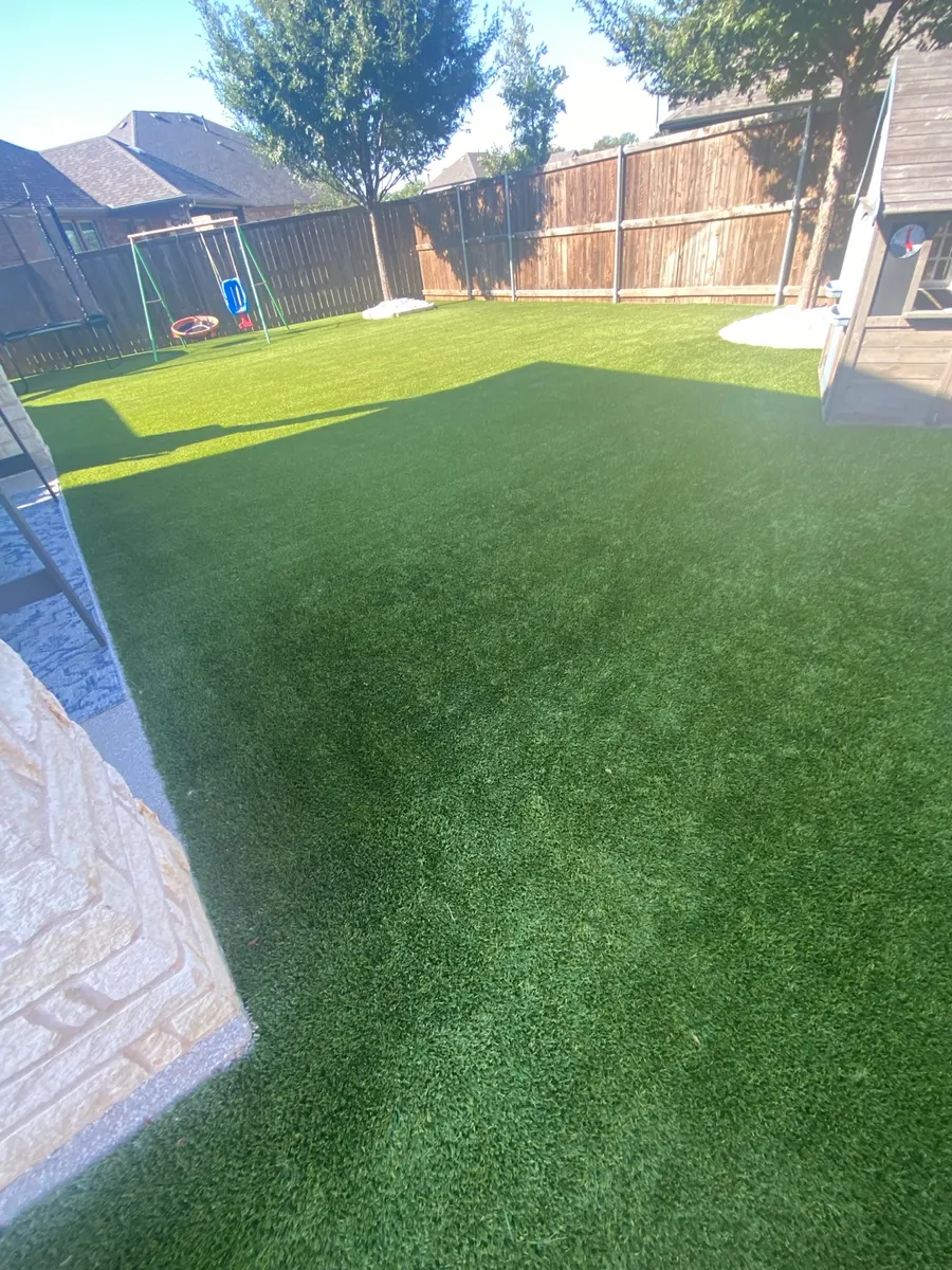 Finished 1,600-square-foot residential artificial turf lawn after professional cleaning in Denton, Texas