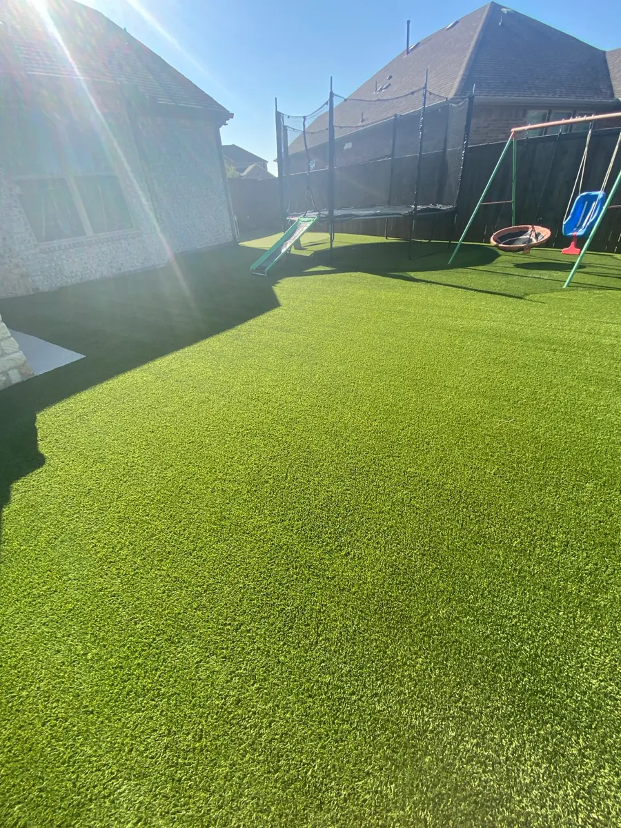Wide finished view of a 1,600-square-foot residential artificial turf lawn after cleaning in Denton, Texas