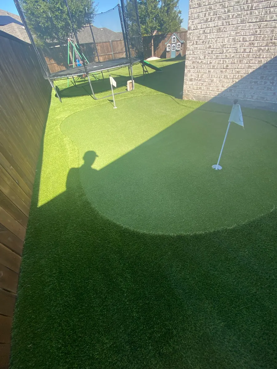 Backyard putting green and surrounding artificial turf after professional cleaning in Denton, Texas