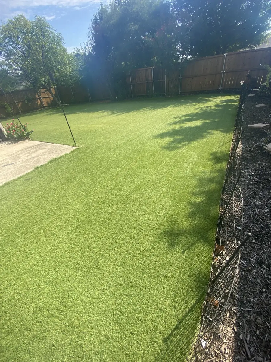 Finished 1,600-square-foot residential artificial turf lawn after professional cleaning in McKinney, Texas