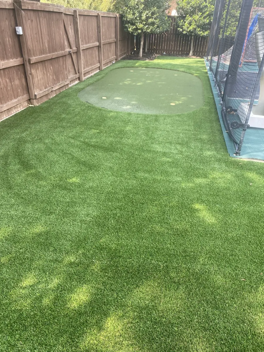 Clean artificial turf around a residential play area after service