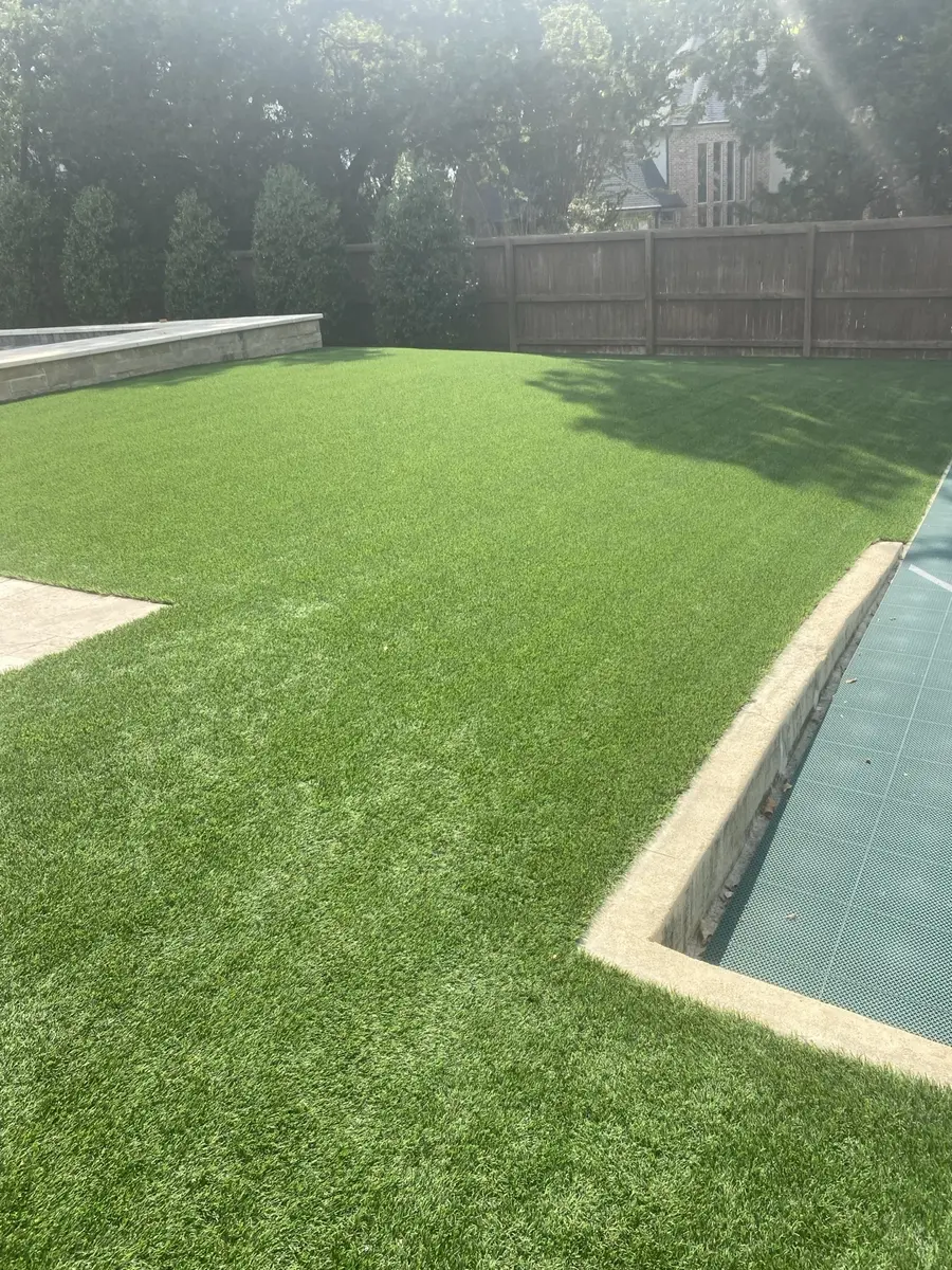 Large residential artificial turf lawn beside a swimming pool after professional cleaning in Southlake, Texas