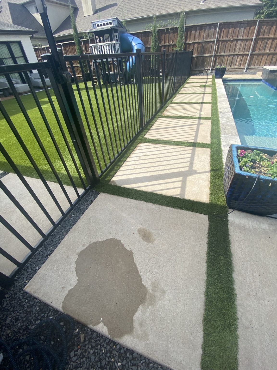 Finished 900-square-foot residential artificial turf around a fenced pool after professional cleaning in Dallas, Texas