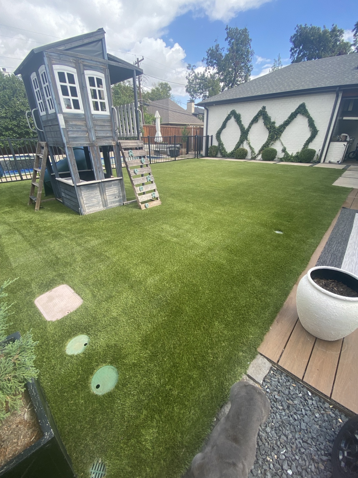 Finished artificial turf lawn and play area after a 900-square-foot residential cleaning in Dallas, Texas