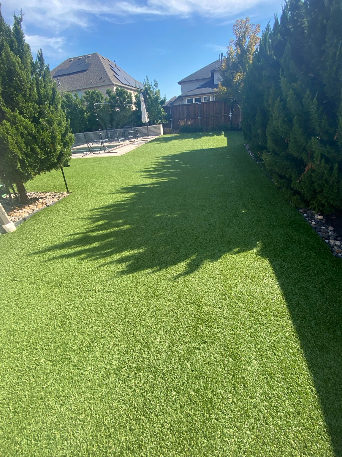 Finished 900-square-foot residential artificial turf lawn after cleaning in Frisco, Texas