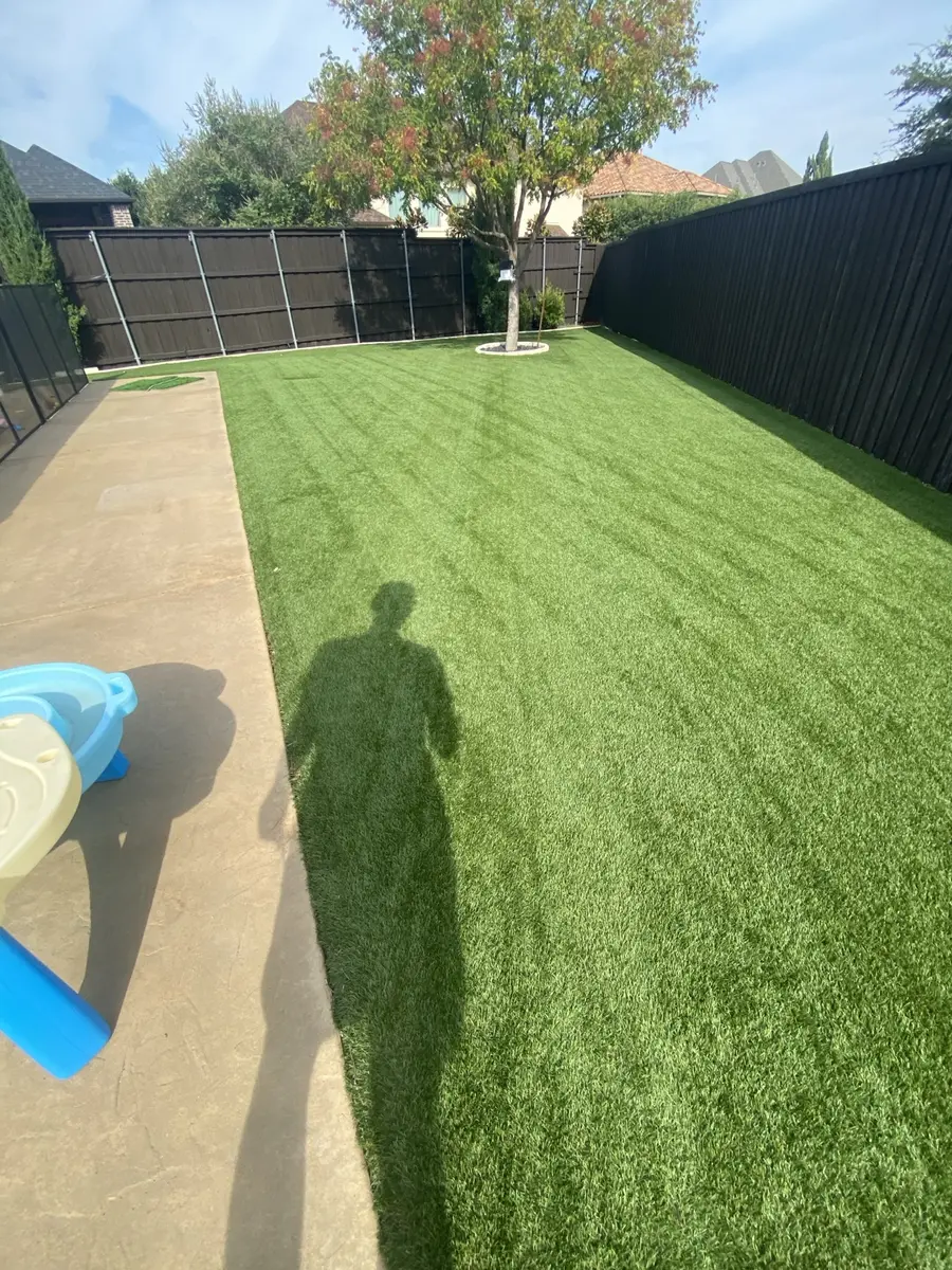 Completed cleaning and grooming on a large residential artificial turf lawn