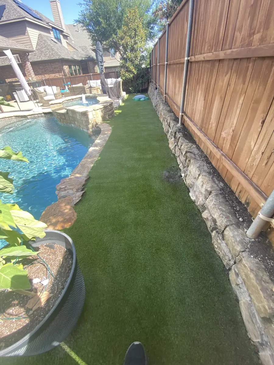 Freshly groomed artificial turf along a residential pool
